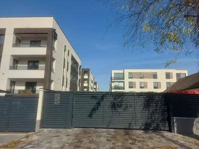 a gate in front of a building with buildings in the background at Danube View 11 in Zemun