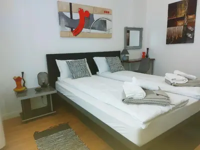 a bedroom with two beds with white sheets at Danube View 11 in Zemun