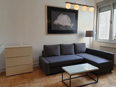 a living room with a couch and a table at Apartment Theatre in Belgrade