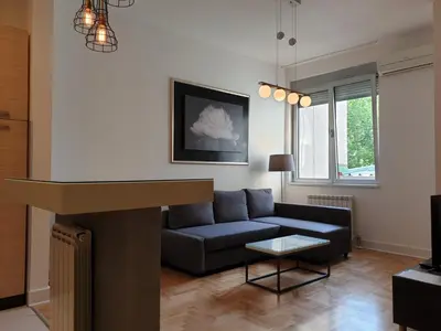 a living room with a couch and a table at Apartment Theatre in Belgrade