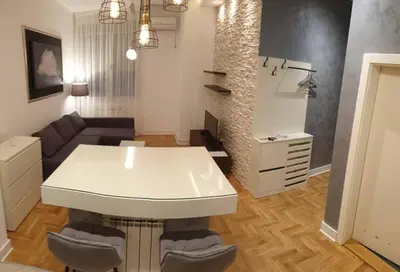 a living room with a white table and a couch at Apartment Theatre in Belgrade
