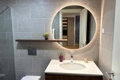 a bathroom with a sink and a mirror at Belgrade Waterfront Premium LuX Apartment in Sajmište