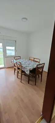 a dining room with a table and two chairs at Čiča 1 in Dobanovci