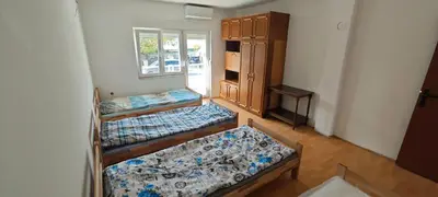 a room with two bunk beds and a window at Čiča 1 in Dobanovci