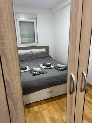 a bedroom with a bed with two phones on it at D2Apartman 1 in Belgrade