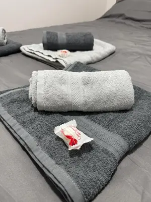 a group of towels sitting on top of a bed at D2Apartman 1 in Belgrade
