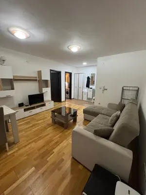 a living room with a couch and a table at D2Apartman 1 in Belgrade