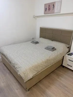 a bed in a room with a white wall at Sofija in Belgrade