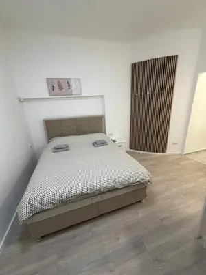 a bedroom with a bed and a wooden floor at Sofija in Belgrade