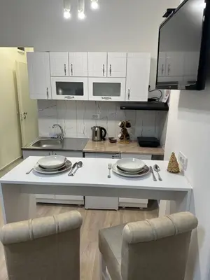 a kitchen with white cabinets and a white counter top at Sofija in Belgrade