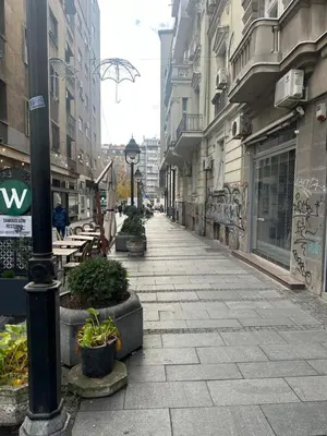 an empty street in a city with buildings at Sofija in Belgrade