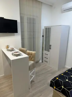 a living room with a white table and a cabinet at Sofija in Belgrade