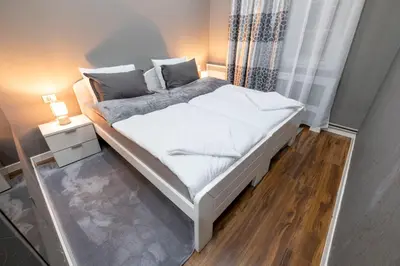 a bed with white sheets and pillows in a bedroom at Beo City Apartmani in Belgrade