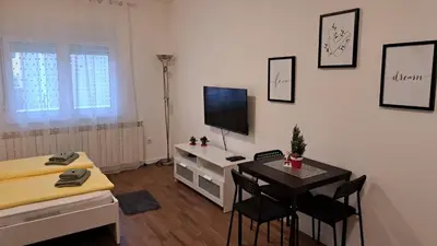 a living room with a desk and a television at Apartment Sanja in Belgrade
