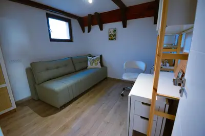 a living room with a couch and a desk at Kosmaj Escape in Koraćica