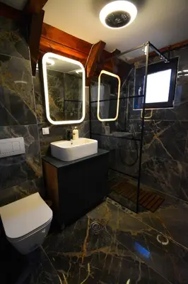 a bathroom with a sink and a toilet and a mirror at Kosmaj Escape in Koraćica