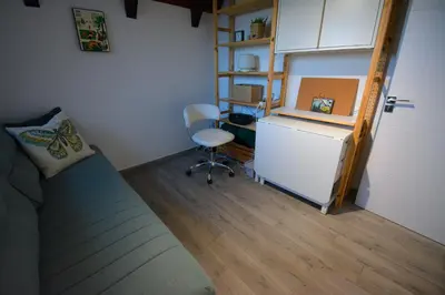 a room with a couch and a refrigerator and a desk at Kosmaj Escape in Koraćica