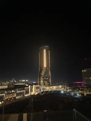 a tall building with lights on it at night at Belgrade Waterfront luxury apartment & free parking in Belgrade