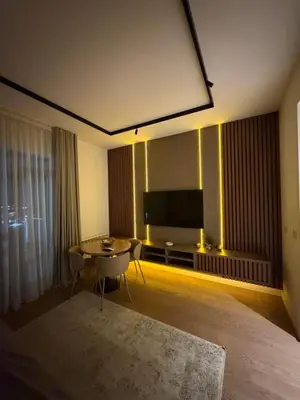 a living room with a tv and a table and a couch at Belgrade Waterfront luxury apartment & free parking in Belgrade