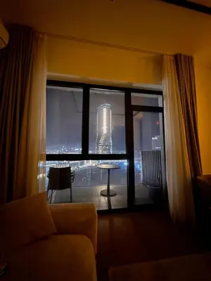 a living room with a view of a building from a window at Belgrade Waterfront luxury apartment & free parking in Belgrade