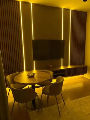 a living room with a table and chairs and a television at Belgrade Waterfront luxury apartment & free parking in Belgrade