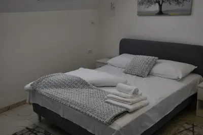 a bed with two towels on top of it at Villa 1869 Zemun in Belgrade