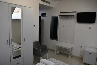 a room with a mirror and a chair and a window at Villa 1869 Zemun in Belgrade