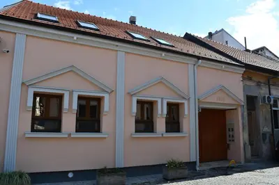 a white building with windows and a roof at Villa 1869 Zemun in Belgrade