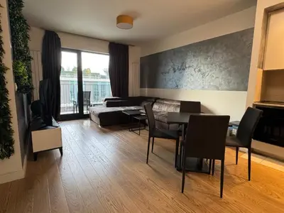 a living room with a couch and a table and chairs at Belgrade Waterfront Apartments 3 in Belgrade