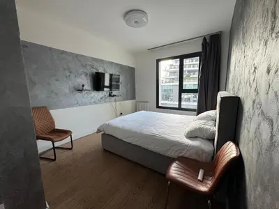 a small bedroom with a bed and a window at Belgrade Waterfront Apartments 3 in Belgrade