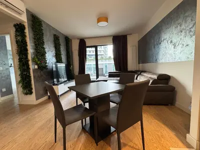 a living room with a table and chairs and a couch at Belgrade Waterfront Apartments 3 in Belgrade