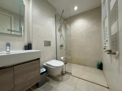 a bathroom with a shower and a toilet and a sink at Belgrade Waterfront Apartments 3 in Belgrade