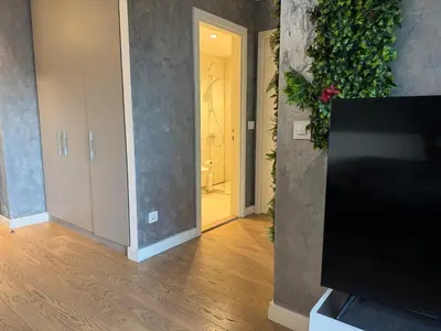 a living room with a television and a hallway at Belgrade Waterfront Apartments 3 in Belgrade