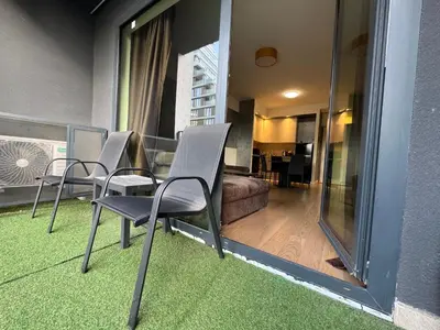 a room with chairs and a table and a living room at Belgrade Waterfront Apartments 3 in Belgrade