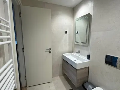 a bathroom with a sink and a mirror at Belgrade Waterfront Apartments 3 in Belgrade