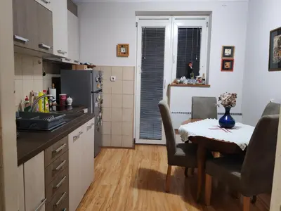 a kitchen with a table with chairs and a dining room at Signorina in Smederevo
