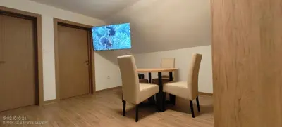 a dining room with a table and two chairs at Dušan in Beograd