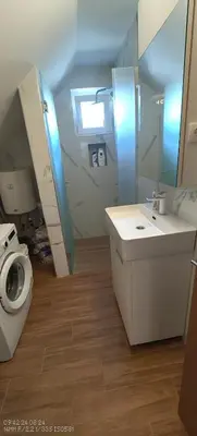 a bathroom with a toilet and a sink and a mirror at Dušan in Beograd
