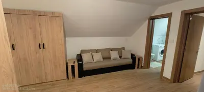 a living room with a couch with two pillows at Dušan in Beograd