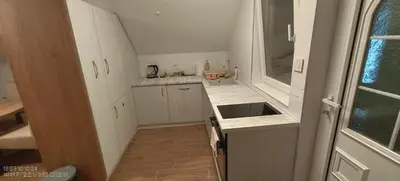a small kitchen with white cabinets and a sink at Dušan in Beograd