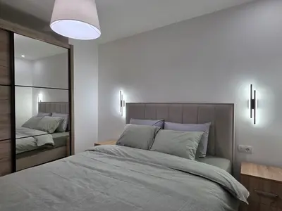 a bedroom with a large bed and a mirror at Masa in Arandjelovac