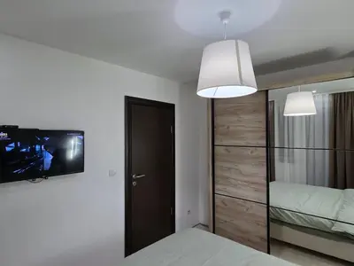 a bedroom with a bed and a tv on the wall at Masa in Arandjelovac