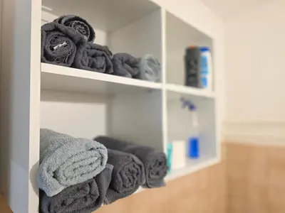 a shelf filled with towels in a bathroom at Masa in Arandjelovac