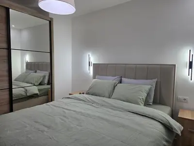 a bedroom with a large bed and a mirror at Masa in Arandjelovac