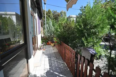 a side walk with a fence and some plants at Botanical Hideout - Near Botanical Garden & City Center in Belgrade