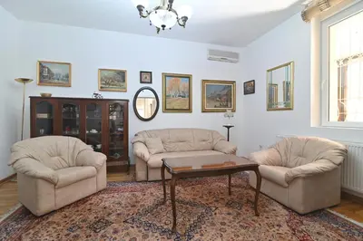 a living room with two chairs and a coffee table at Botanical Hideout - Near Botanical Garden & City Center in Belgrade