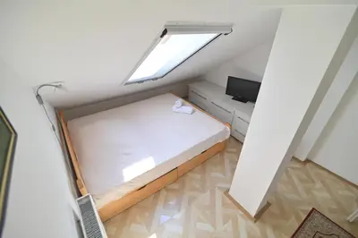 a small bedroom with a bed and a window at Botanical Hideout - Near Botanical Garden & City Center in Belgrade