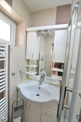 a bathroom with a sink and a mirror at Botanical Hideout - Near Botanical Garden & City Center in Belgrade