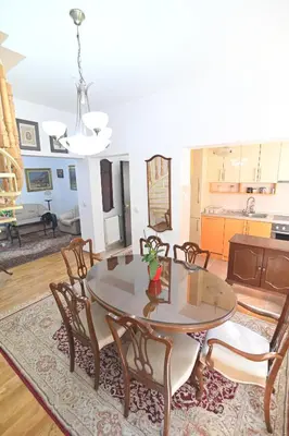 a dining room with a table and chairs at Botanical Hideout - Near Botanical Garden & City Center in Belgrade