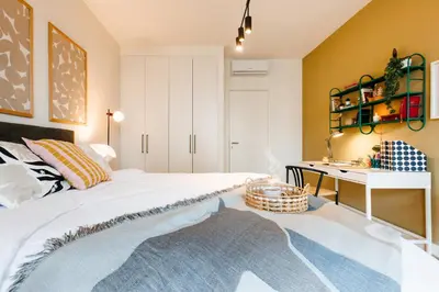 a bedroom with a white bed and a desk at WF Sky Charm with Terraces & Billiard in Belgrade